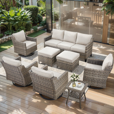 Belord 8-piece patio conversation set with sofa, four swivel chairs, two ottomans, and side tables in a stylish outdoor setting