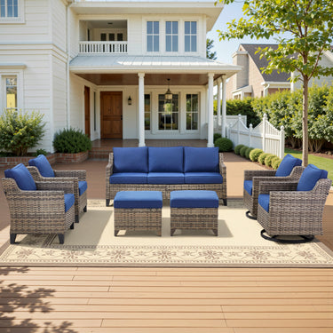 Belord 7-piece patio conversation set with wicker sofa, swivel chairs, and ottomans for outdoor lounging and entertaining.