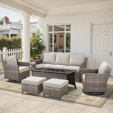 Belord 7-piece patio conversation set with sofa, two swivel chairs, coffee table, and two ottomans in outdoor setting.