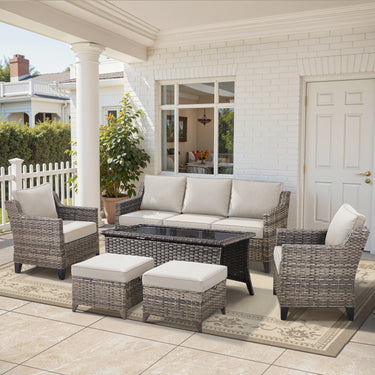 Belord 6-piece outdoor lounge set with hand-woven wicker sofa, patio chairs, coffee table, ottomans, and cushioned seating.