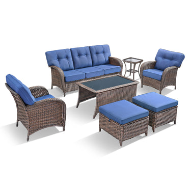 Belord 7-piece patio conversation set with brown wicker frame, blue cushions, including sofa, chairs, tables, and footstools.