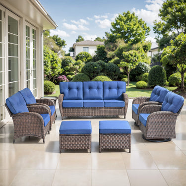Belord outdoor patio conversation set with brown wicker sofa, blue cushions, swivel rocking chairs, patio chairs, side table, and footstools.