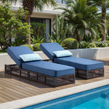 Set of 2 Belord luxury patio chaise lounges with brown wicker frames and blue cushions, featuring reclining backs for poolside relaxation.