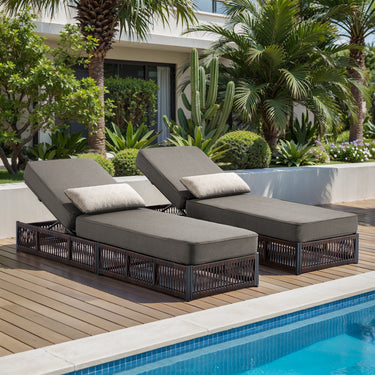 Pair of Belord luxury chaise lounges with brown wicker frames, grey cushions, reclining backs, ideal for poolside patio relaxation.