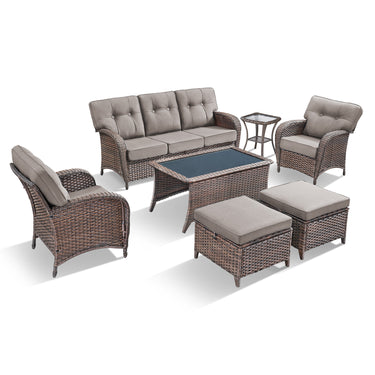 Belord 7-piece patio conversation set with brown wicker, grey cushions, includes sofa, chairs, tables, and footstools.