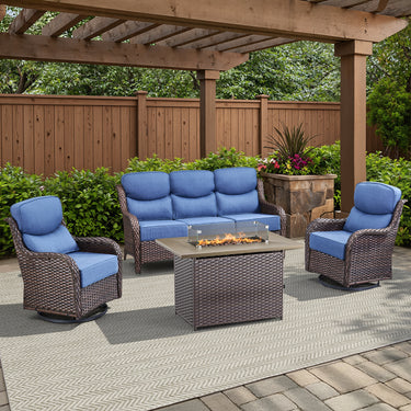 Belord small patio fire pit set with brown wicker swivel chairs, blue cushions, and rectangular fire table with wind guard.