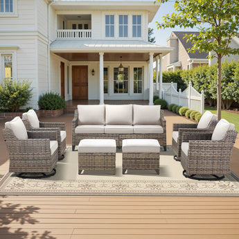 Belord 7-piece patio conversation set with sofa, four swivel chairs, and two ottomans, made of PE wicker for outdoor lounging.