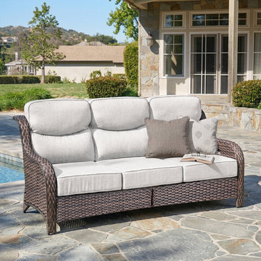 Belord oversized 3-seater wicker sofa with high back and 6-inch cushions, ideal for outdoor or patio lounging.