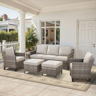 Belord 6-piece wicker patio conversation set with sofa, two chairs, two ottomans, and side table for outdoor lounging.