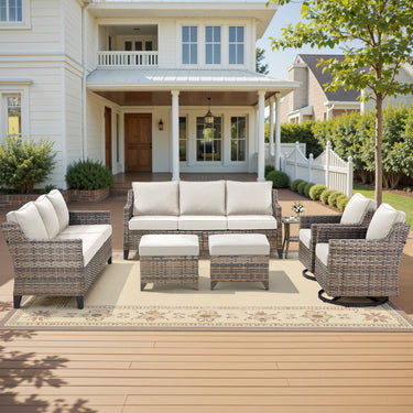 Belord 7-piece patio conversation set with sofas, swivel chairs, ottomans, and side table in outdoor garden setting