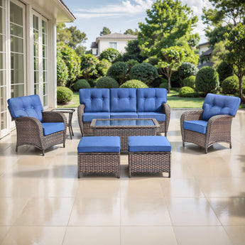 Belord 7-piece patio conversation set with brown wicker, blue cushions, including sofa, chairs, tables, and footstools.