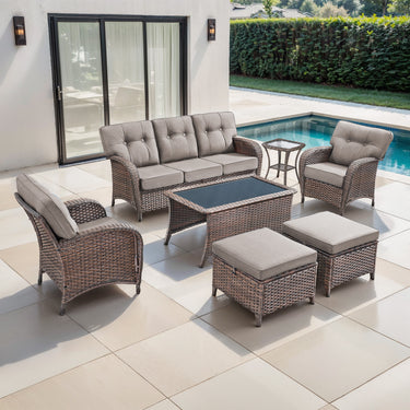 Belord 7-piece patio set with brown wicker, grey cushions, includes sofa, chairs, tables, and footstools for outdoor entertaining.