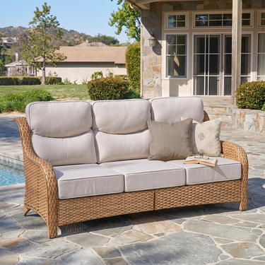 Belord oversized 3-seater wicker sofa with high back and 6-inch cushions, part of the NT Series, shown in a stylish outdoor setting.