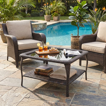 Belord outdoor wicker coffee table with glass top and two-tier storage, part of the NTC series patio conversation sets.